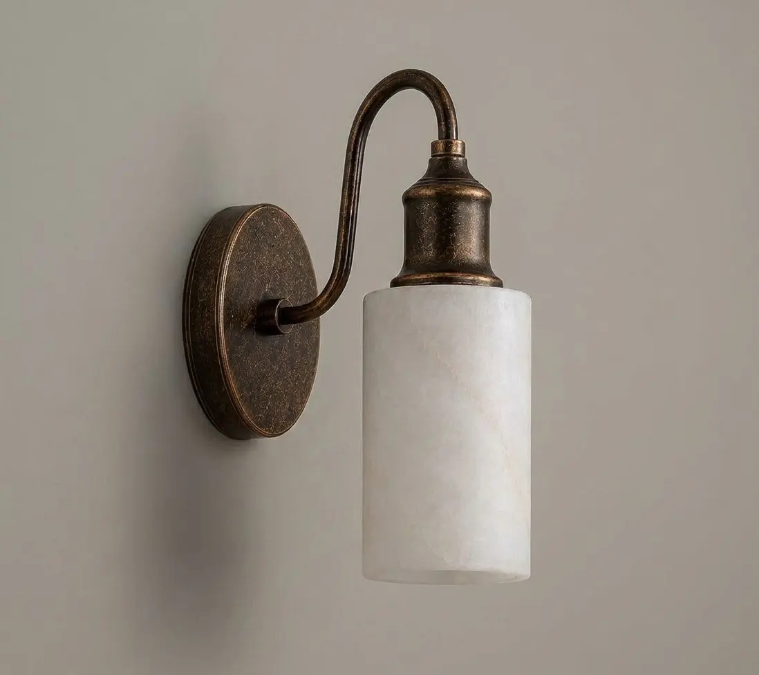 Gooseneck alabaster cylinder wall sconce, warm lit, on a plain neutral wall